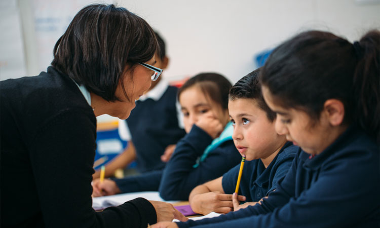 The Magic of Discovery - Teacher assisting students