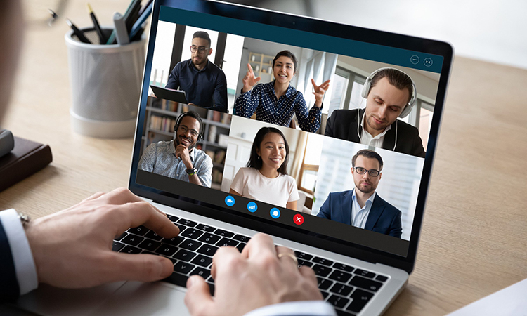 Individuals on a laptop screen